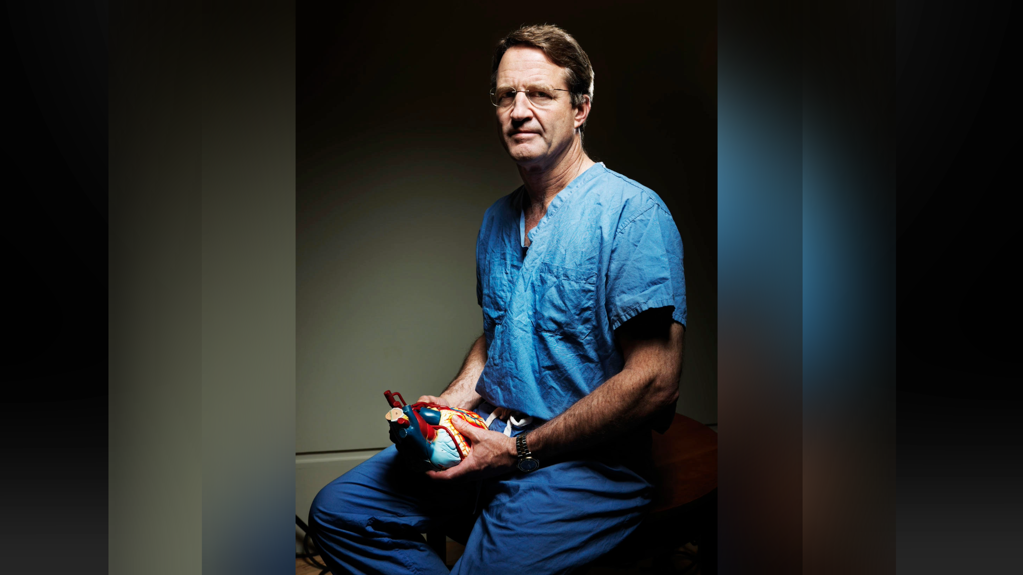 Portrait of Dr. Craig Smith holding an anatomical model of a heart.