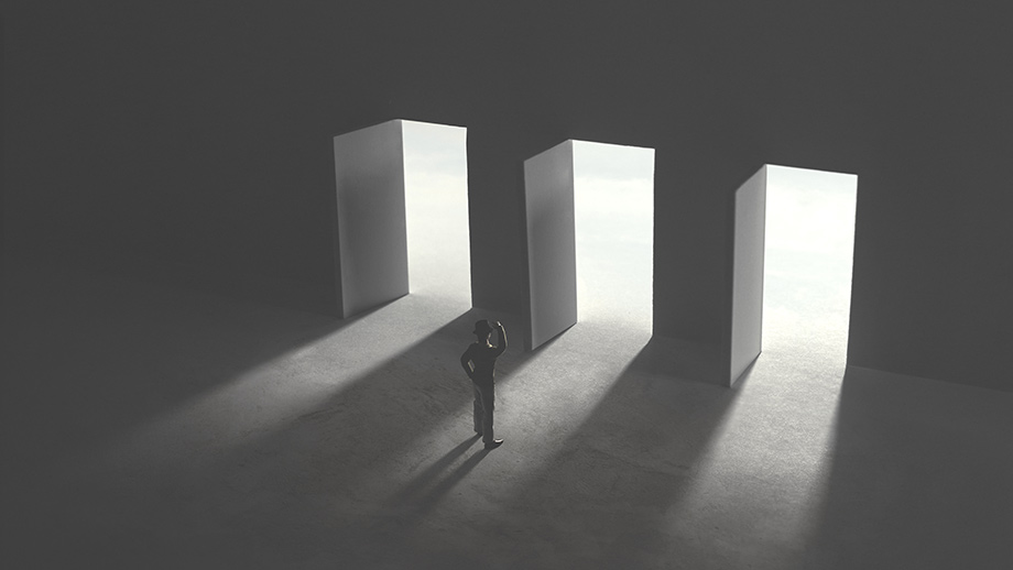 Black and white image of a standing person in doubt in front of a series of three open doors representing three options.