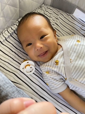 nate smiles at the camera after in bed.